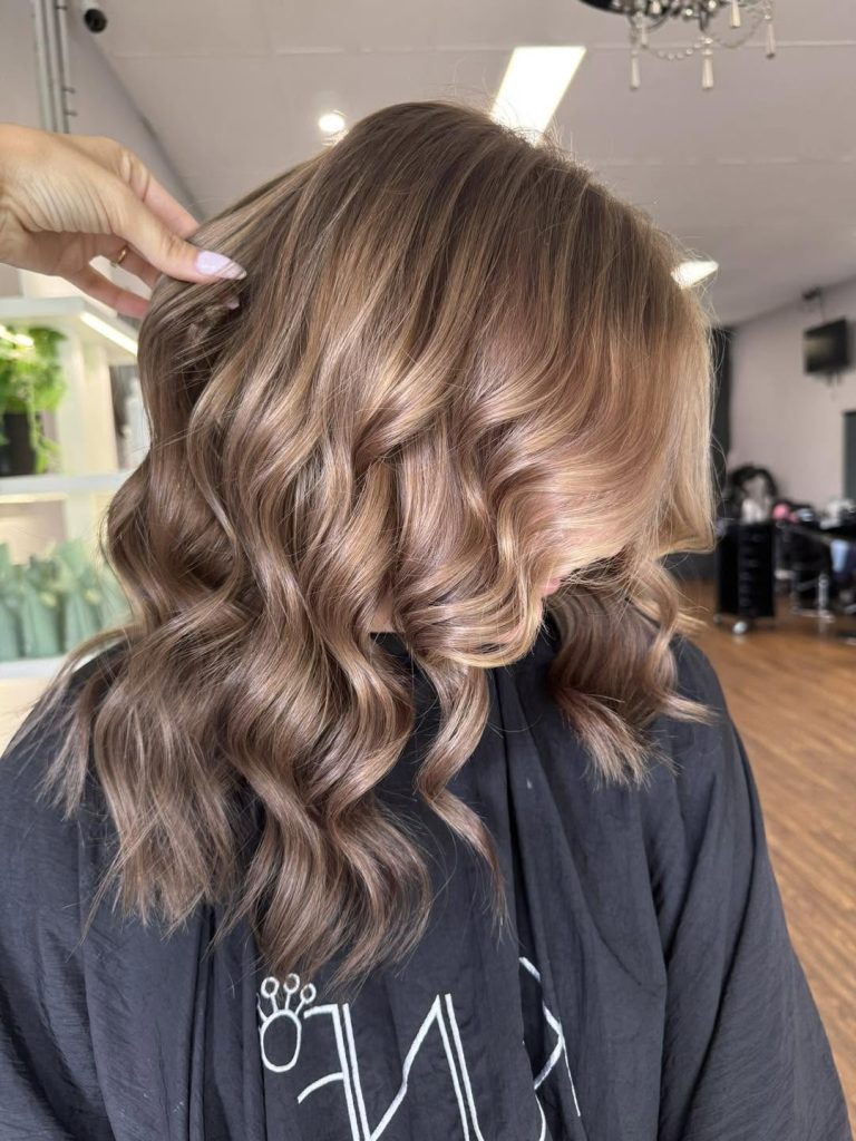 Soft caramel highlights and loose curls at Hair Envy Wallacia